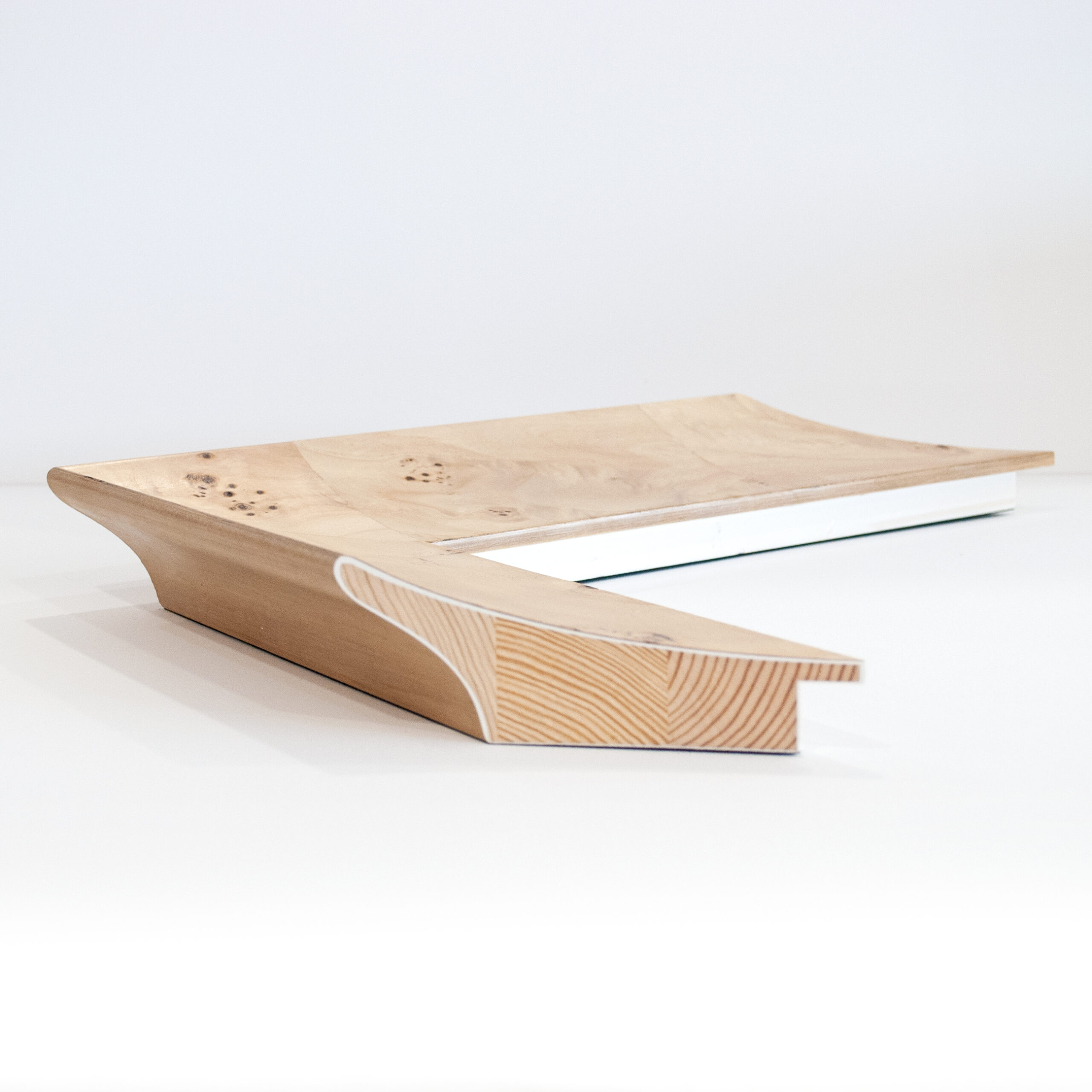 Side view of the Arbour frame profile showing the timber inner, gesso layer and veneer finish