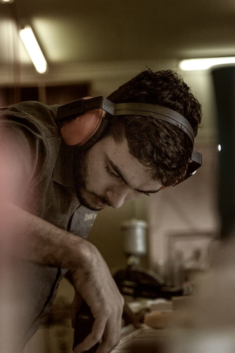 Jacob painstakingly measuring a picture frame profile before cutting it to size at Dawsons Handcrafted, Gold Coast