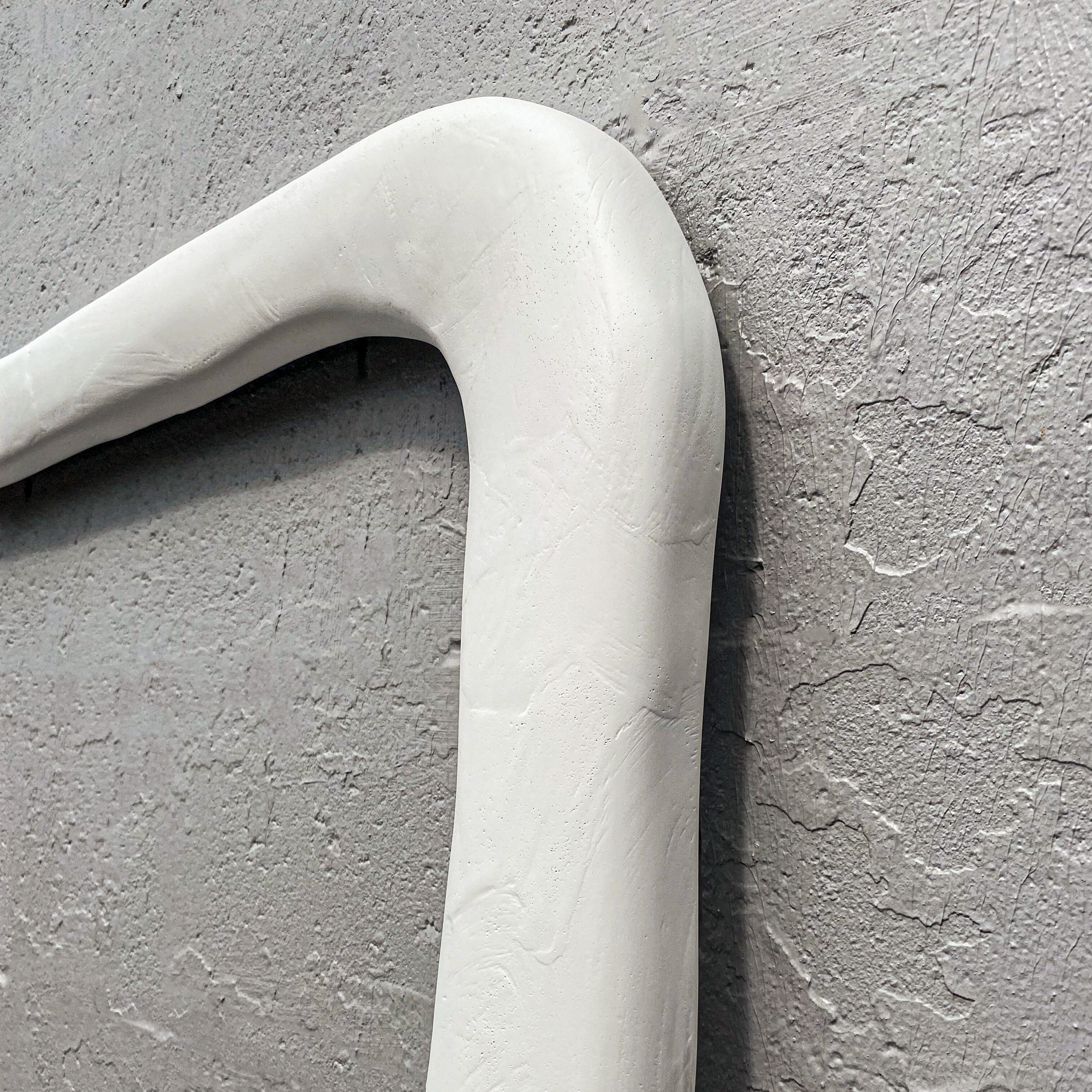 Handcrafted cordelia gesso finished frame against a grey painted wall